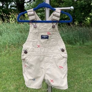 OshKosh: 6-9mos. Boys khaki shortalls with baseball themed embroidery.